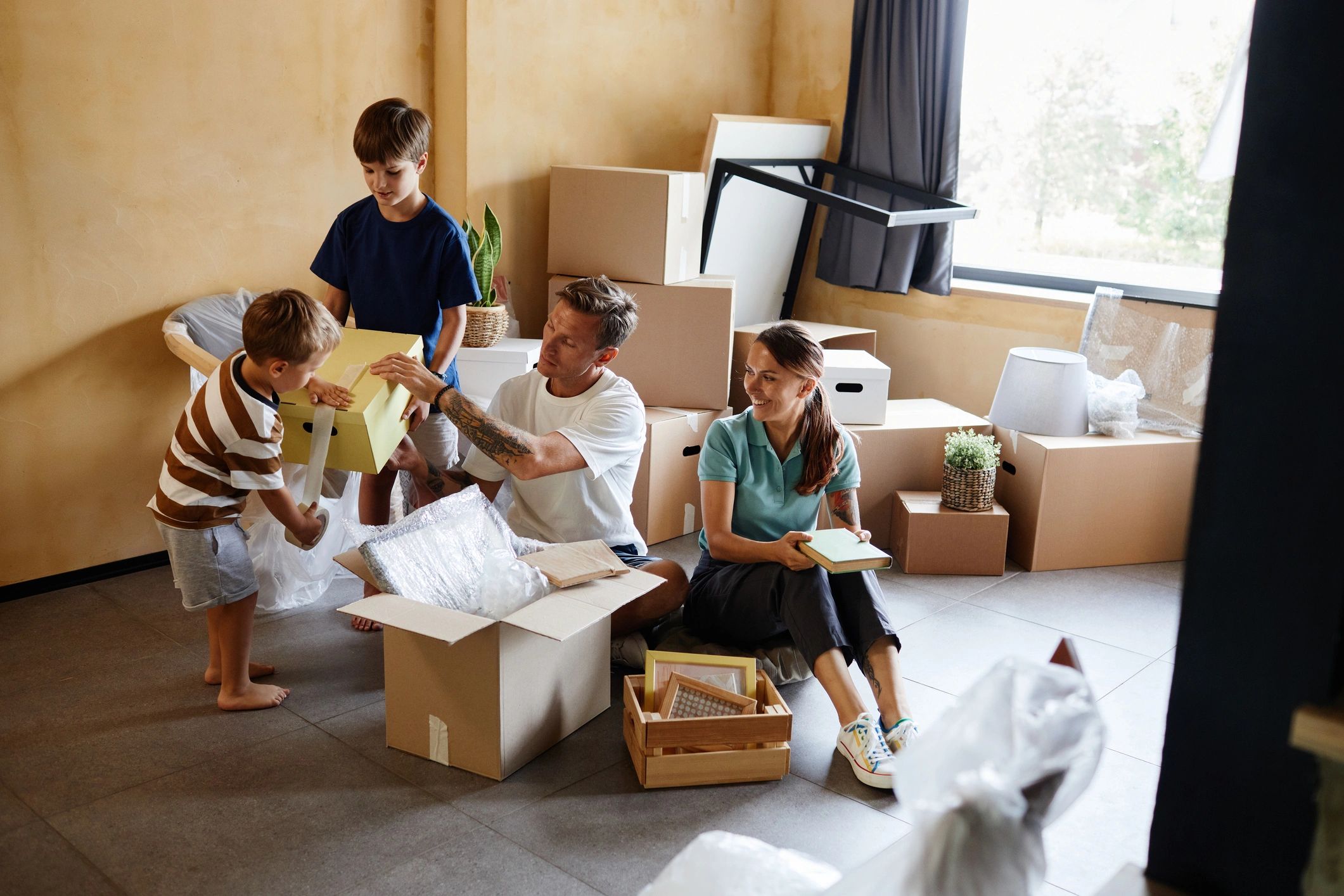Family unpacking boxes in a new home