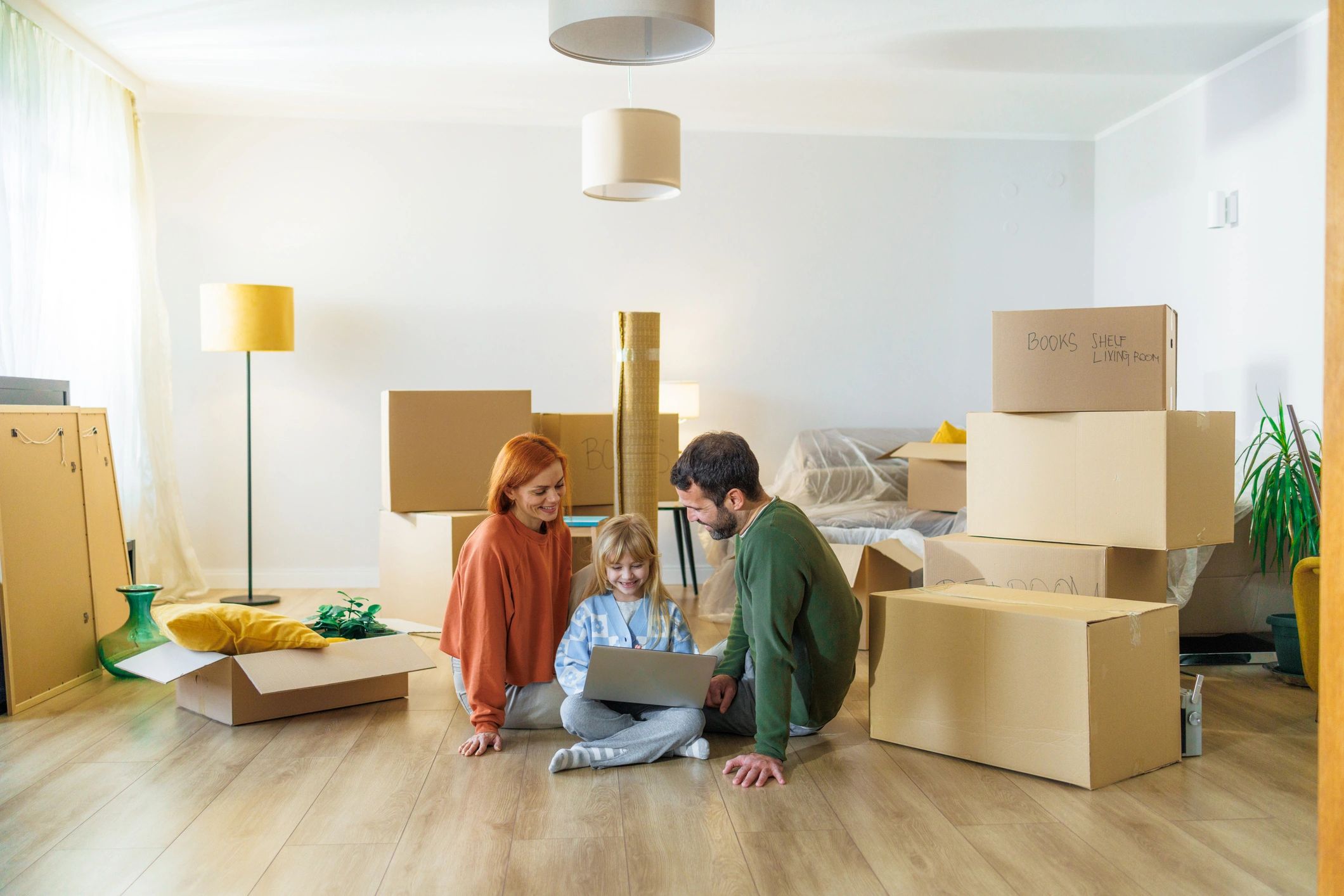 Family surrounded by moving boxes in a new home