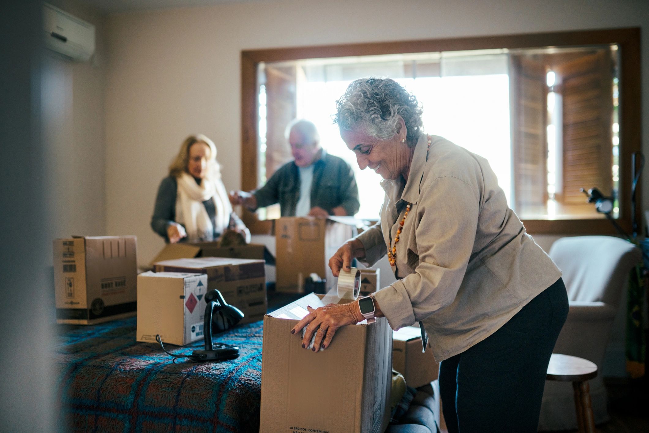 People unpacking moving boxes after a successful move